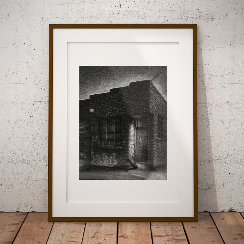 Staffy, Cremorne. 12:04am print in a slim wooden frame with a white mount, leaning against a concrete wall
